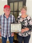 President Jim Burke presenting the million dollars club  certificate in honour of Ron Dafoe to his daughter Tammy Kavanagh